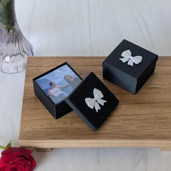 Elegant gift boxes with ribbon bows holding custom photo magnets, prepared for shipping to online customers